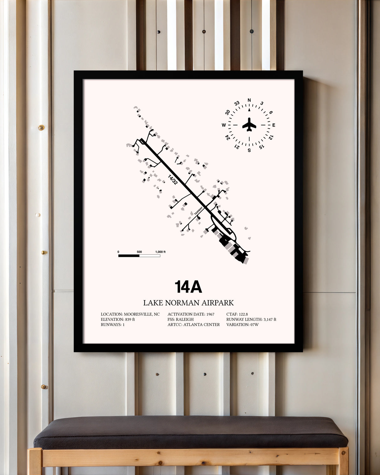 Lake Norman Airpark framed poster displayed in an airplane hangar