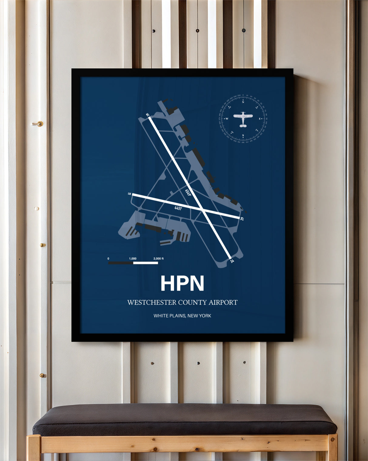 Westchester County Airport framed poster displayed in an airplane hangar
