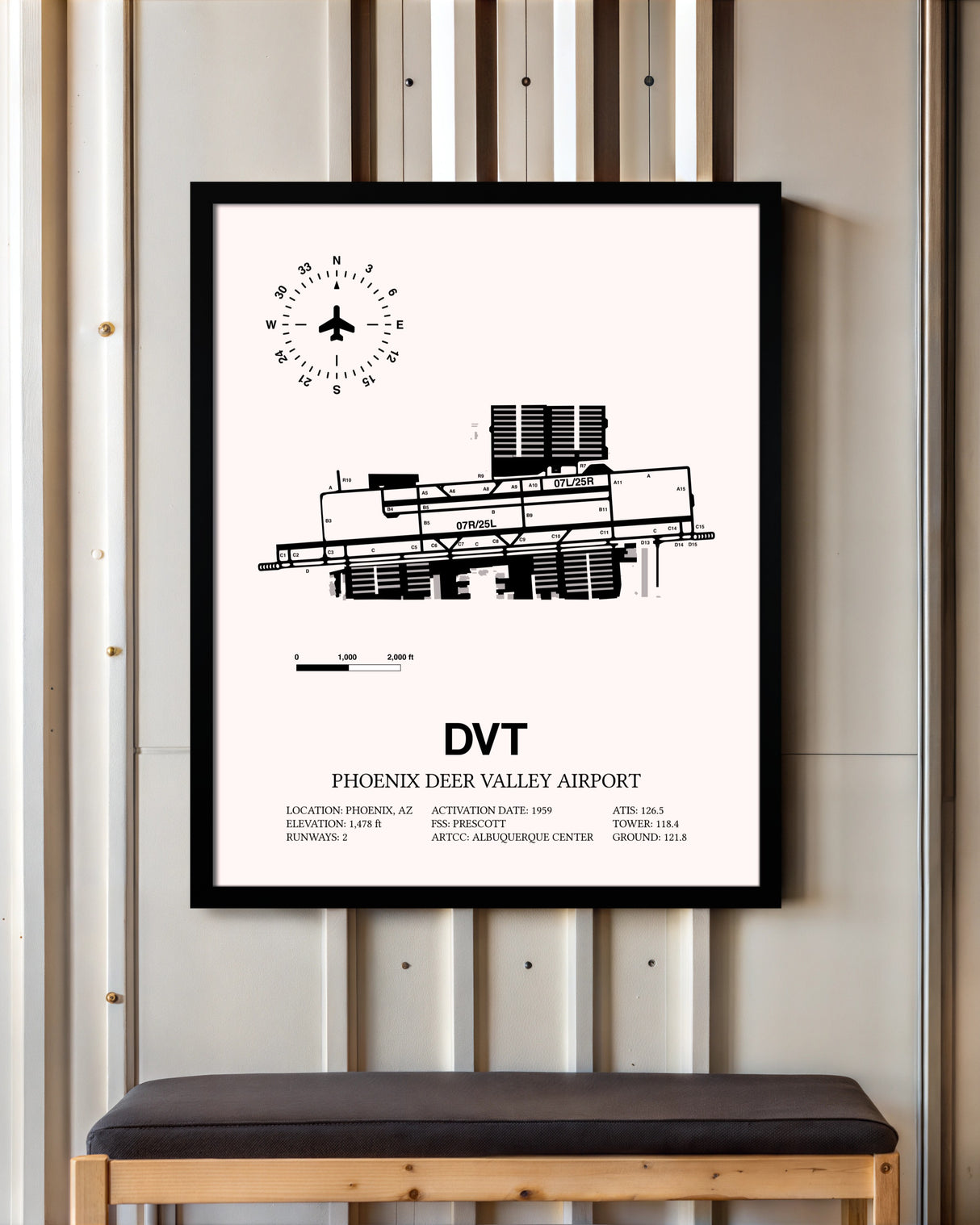 Phoenix Deer Valley Airport framed poster displayed in an airplane hangar