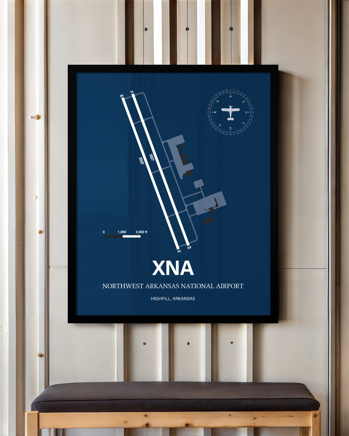 Northwest Arkansas National Airport framed poster displayed in an airplane hangar