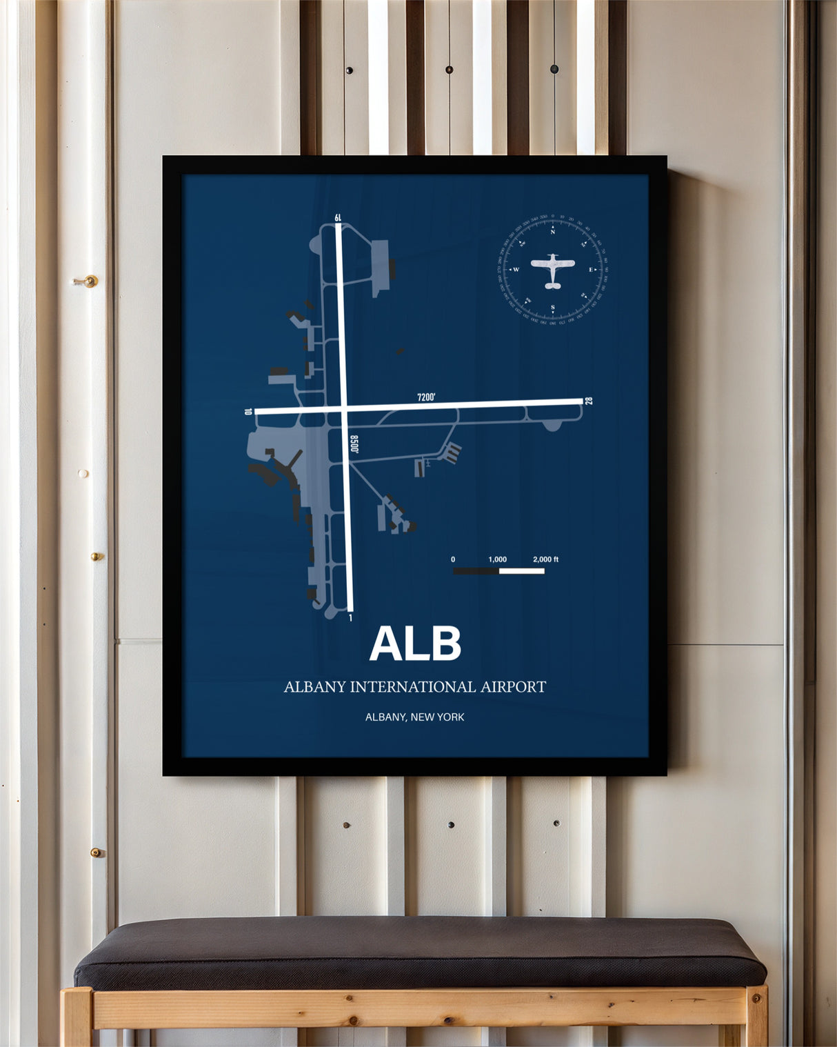 Albany International Airport framed poster displayed in an airplane hangar
