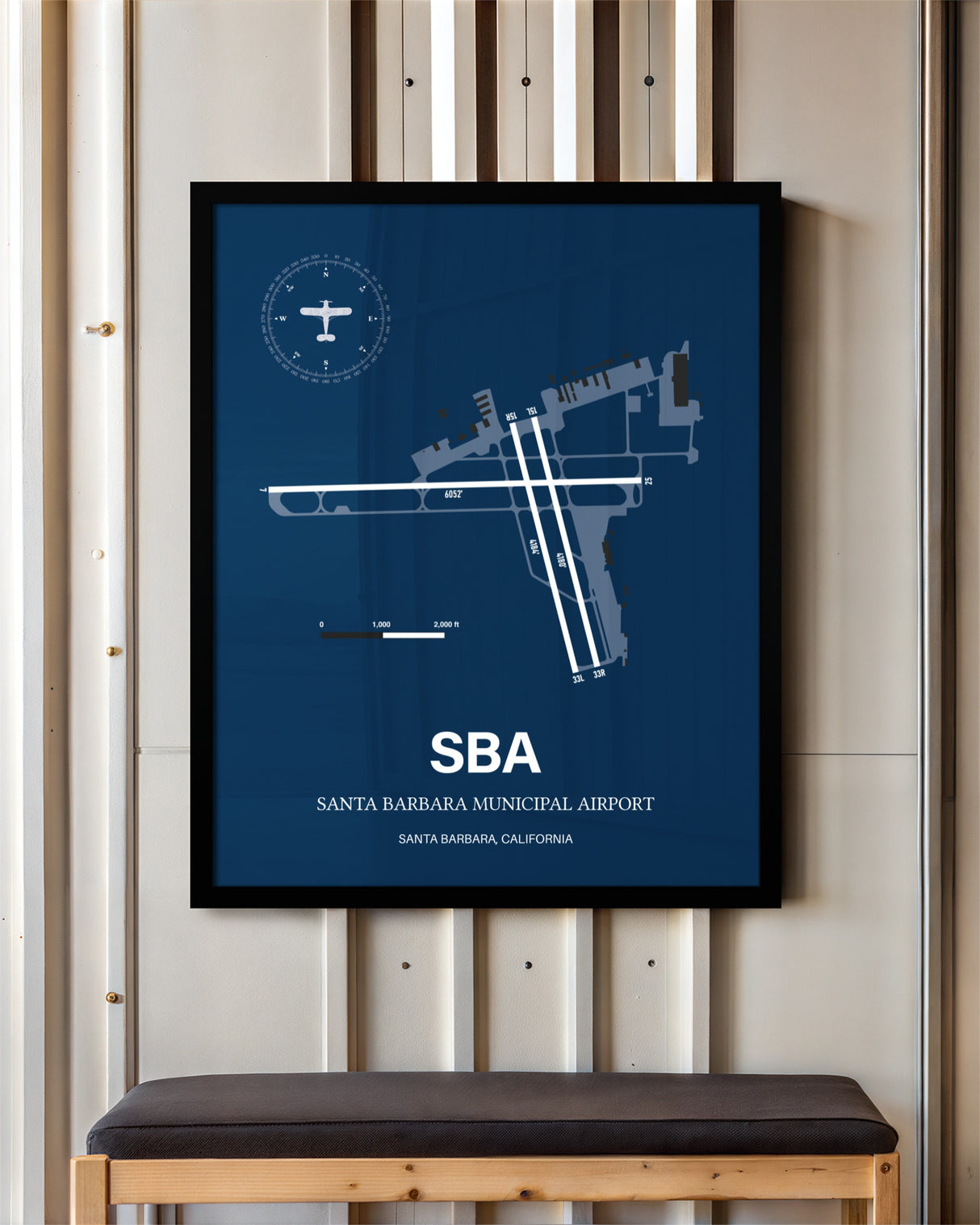 Santa Barbara Municipal Airport framed poster displayed in an airplane hangar