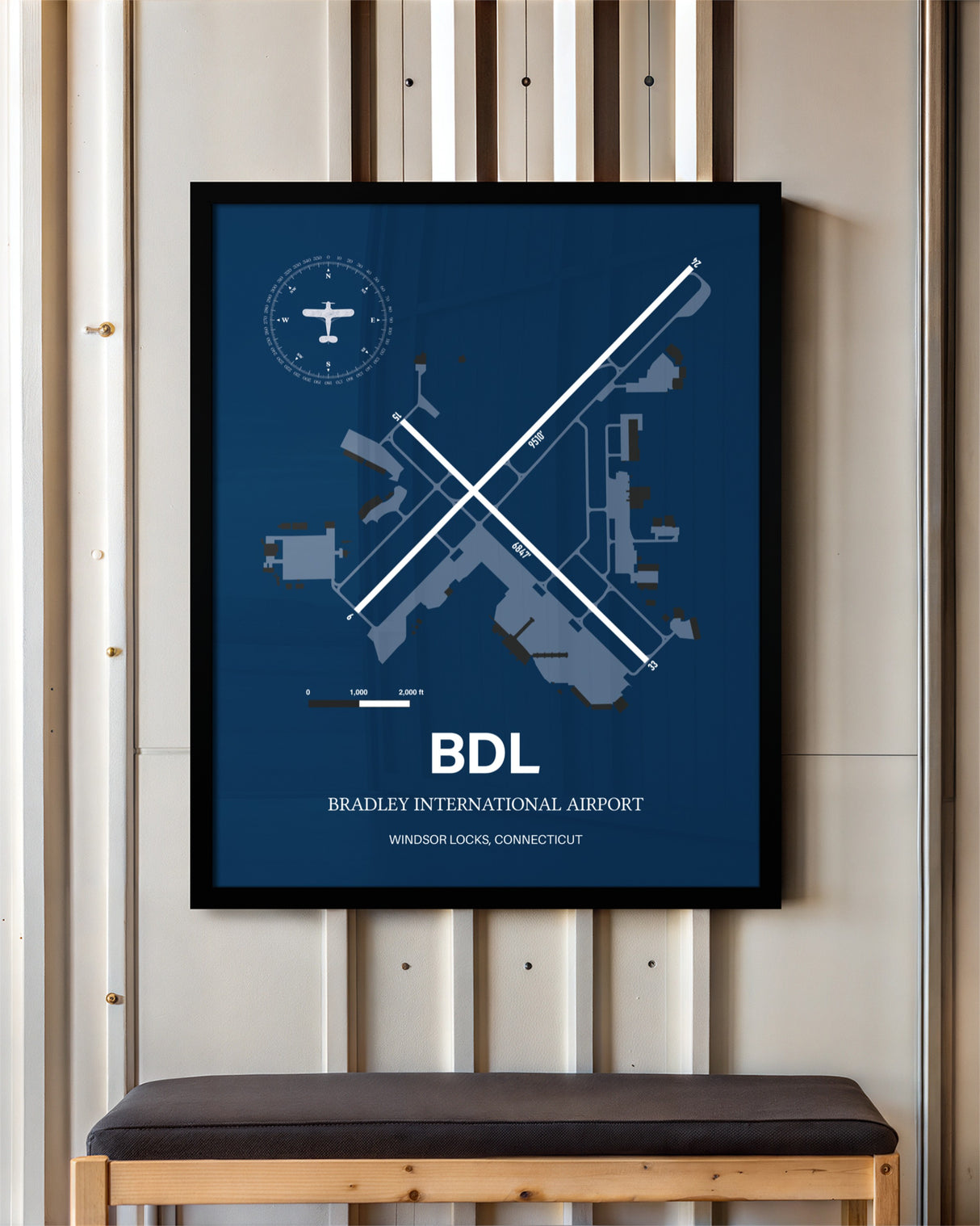 Bradley International Airport framed poster displayed in an airplane hangar