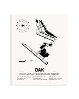 Gray San Francisco Bay Oakland International Airport framed poster displayed in an airplane hangar