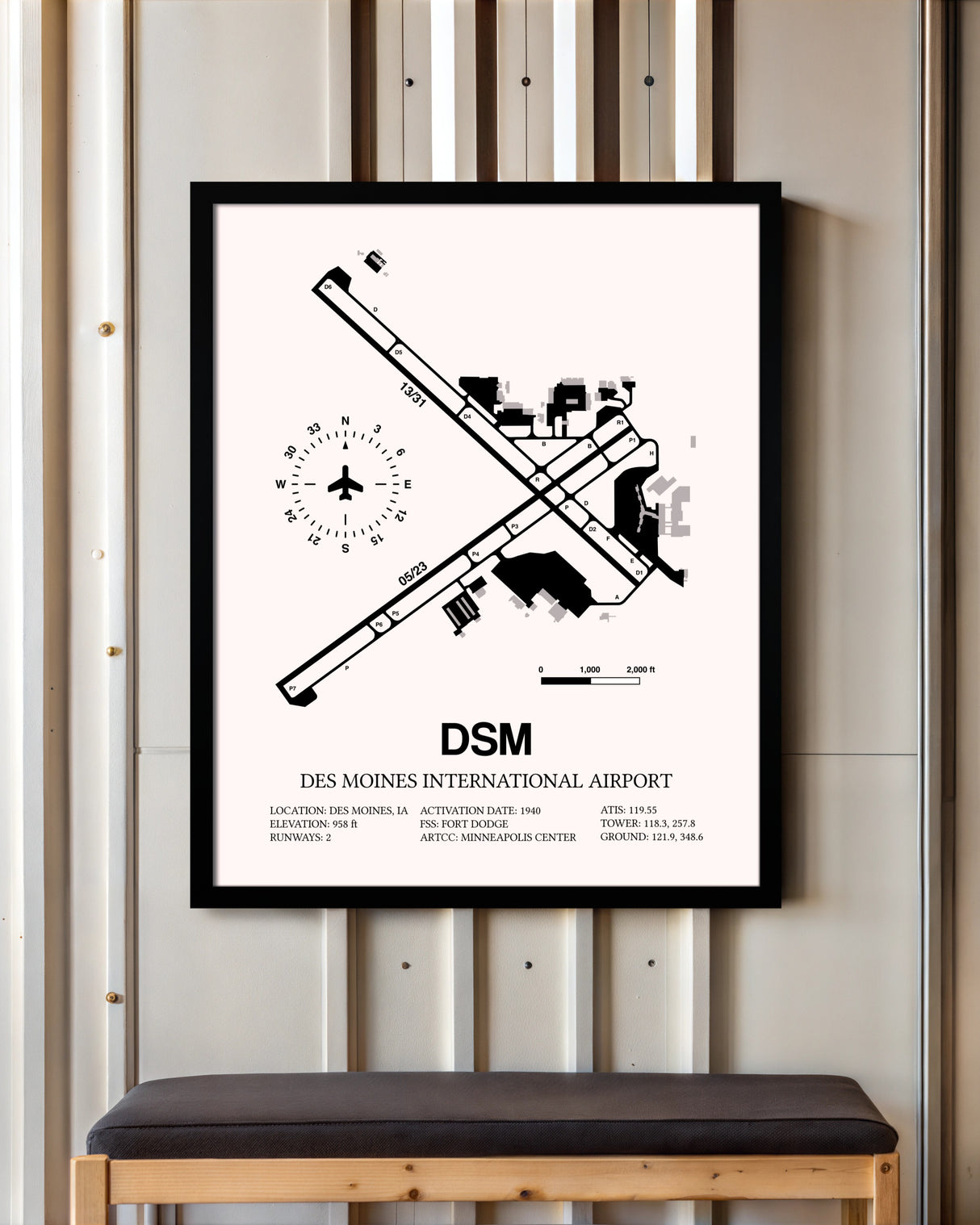 Des Moines International Airport framed poster displayed in an airplane hangar