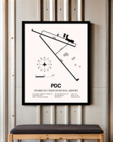 Prairie Du Chien Municipal Airport framed poster displayed in an airplane hangar