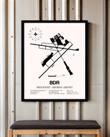 Bridgeport / Sikorsky Airport framed poster displayed in an airplane hangar