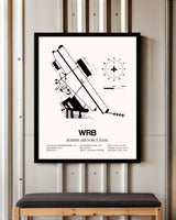 Robins Air Force Base framed poster displayed in an airplane hangar