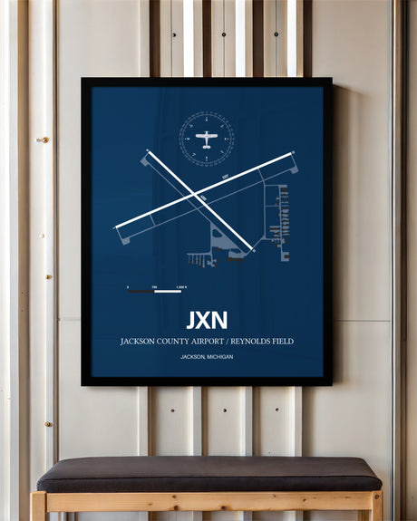 Jackson County Airport/Reynolds Field framed poster displayed in an airplane hangar