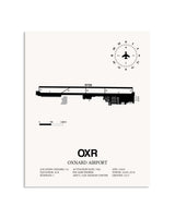 Gray Oxnard Airport framed poster displayed in an airplane hangar