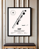 Greenville Spartanburg International Airport framed poster displayed in an airplane hangar