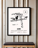 Gerald R. Ford International Airport framed poster displayed in an airplane hangar