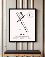New Ulm Municipal Airport framed poster displayed in an airplane hangar