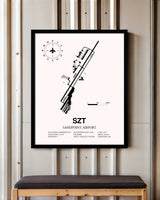 Sandpoint Airport framed poster displayed in an airplane hangar