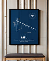 Northwest Alabama Regional Airport framed poster displayed in an airplane hangar