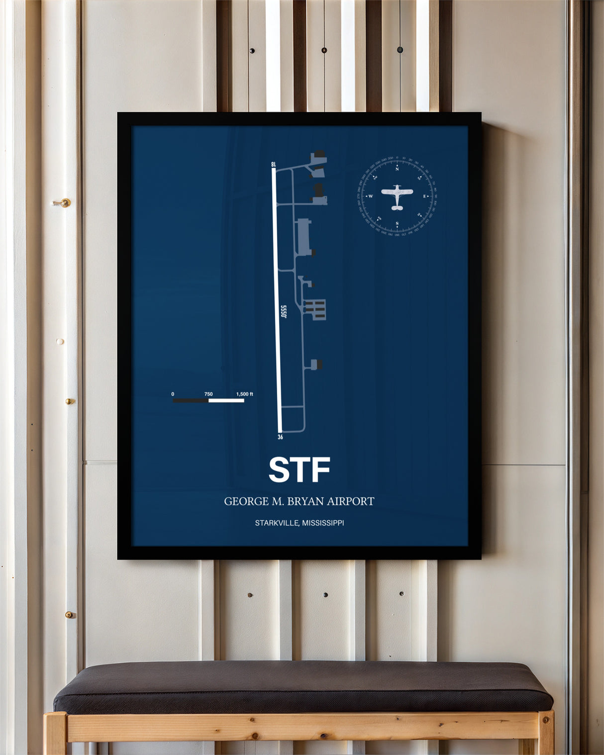 George M. Bryan Airport framed poster displayed in an airplane hangar