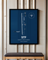 George M. Bryan Airport framed poster displayed in an airplane hangar