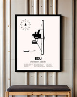University Airport framed poster displayed in an airplane hangar