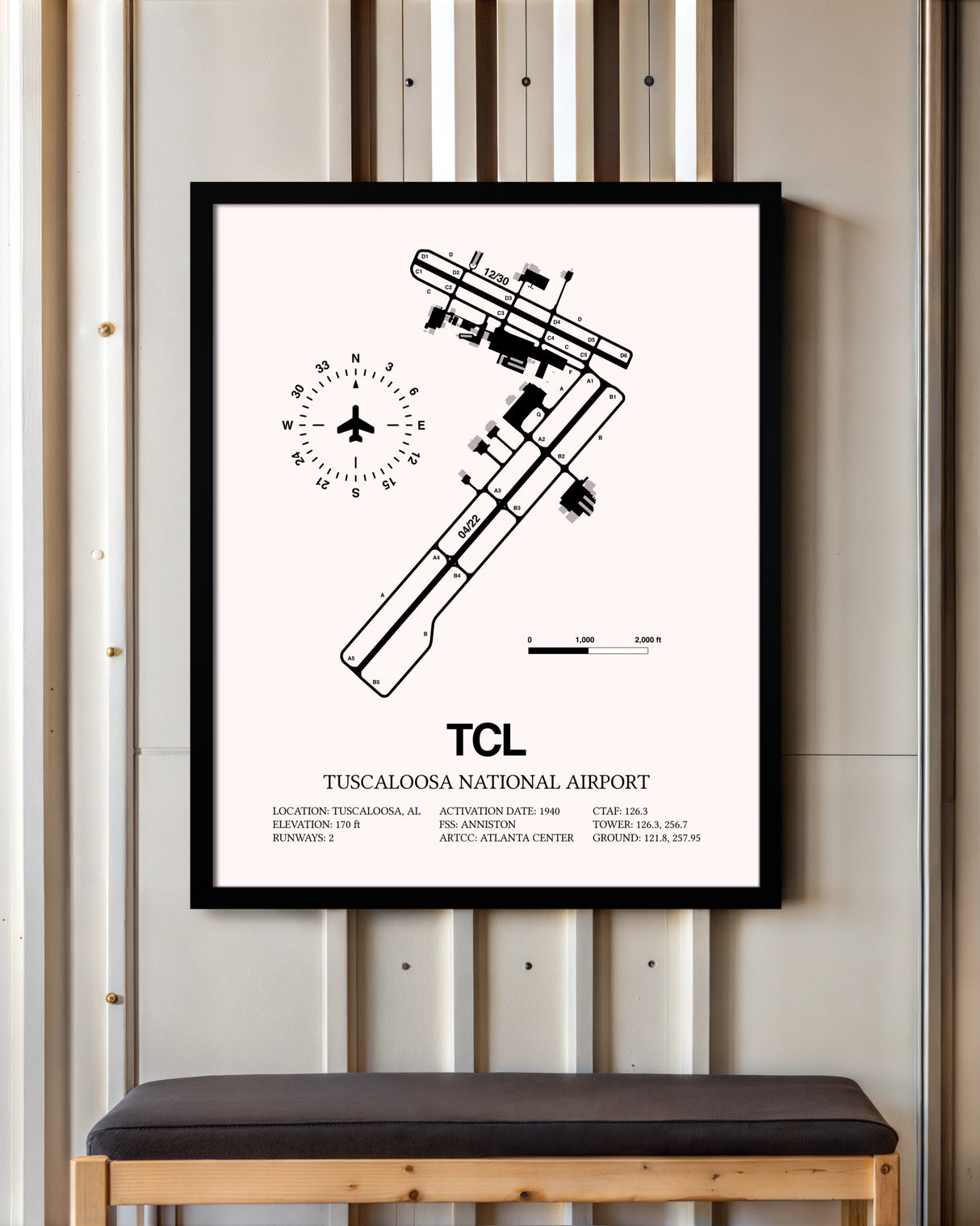 Tuscaloosa National Airport framed poster displayed in an airplane hangar
