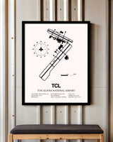 Tuscaloosa National Airport framed poster displayed in an airplane hangar