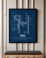 OKC Will Rogers International Airport framed poster displayed in an airplane hangar