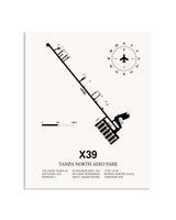 Gray Tampa North Aero Park framed poster displayed in an airplane hangar