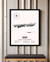 Nevada County Airport framed poster displayed in an airplane hangar