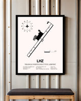 Triangle North Executive Airport framed poster displayed in an airplane hangar