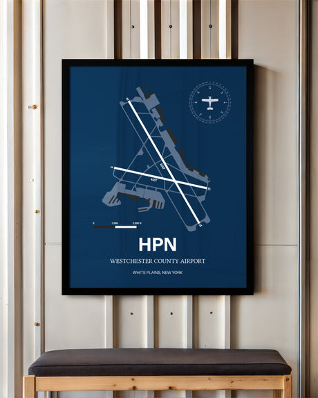 Westchester County Airport framed poster displayed in an airplane hangar