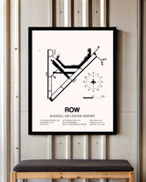 Roswell Air Center Airport framed poster displayed in an airplane hangar