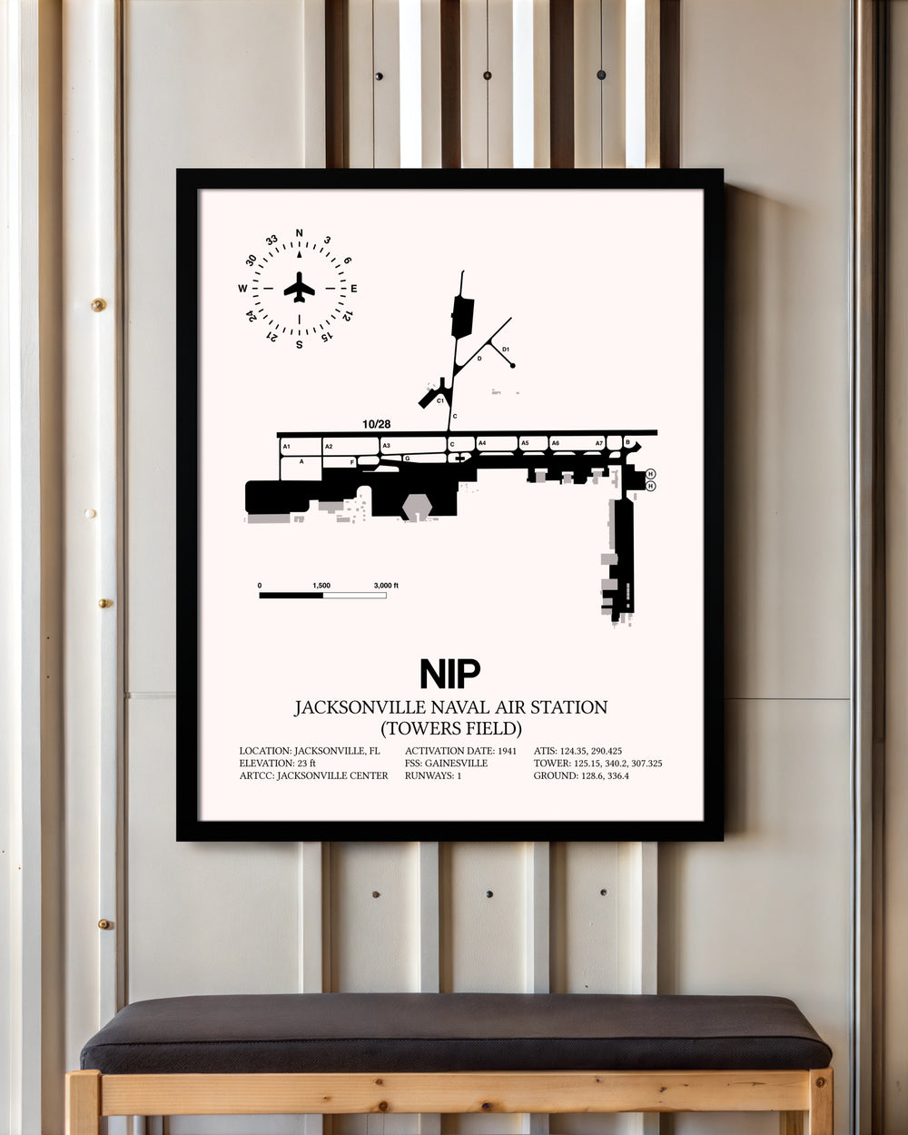 Jacksonville Naval Air Station (Towers Field) framed poster displayed in an airplane hangar