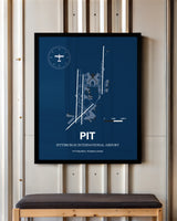 Pittsburgh International Airport framed poster displayed in an airplane hangar
