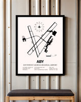 Southwest Georgia Regional Airport framed poster displayed in an airplane hangar
