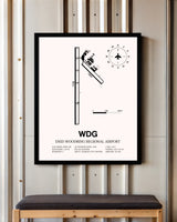 Enid Woodring Regional Airport framed poster displayed in an airplane hangar