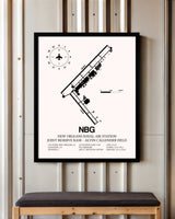 New Orleans Naval Air Station Joint Reserve Base-Alvin Callender Field framed poster displayed in an airplane hangar