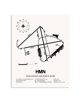 Gray Holloman Air Force Base framed poster displayed in an airplane hangar