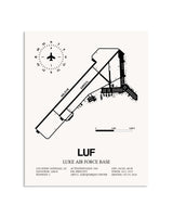 Gray Luke Air Force Base framed poster displayed in an airplane hangar