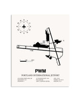 Gray Portland International Jetport framed poster displayed in an airplane hangar