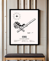 Columbus Airport framed poster displayed in an airplane hangar