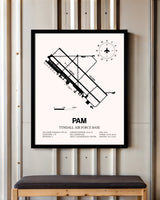 Tyndall Air Force Base framed poster displayed in an airplane hangar