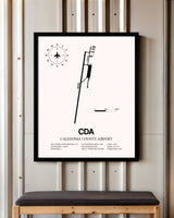 Caledonia County Airport framed poster displayed in an airplane hangar