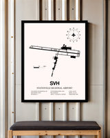 Statesville Regional Airport framed poster displayed in an airplane hangar