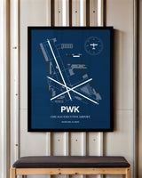 Chicago Executive Airport framed poster displayed in an airplane hangar