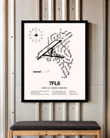 Spruce Creek Airport framed poster displayed in an airplane hangar