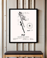 Meadow Lake Airport framed poster displayed in an airplane hangar