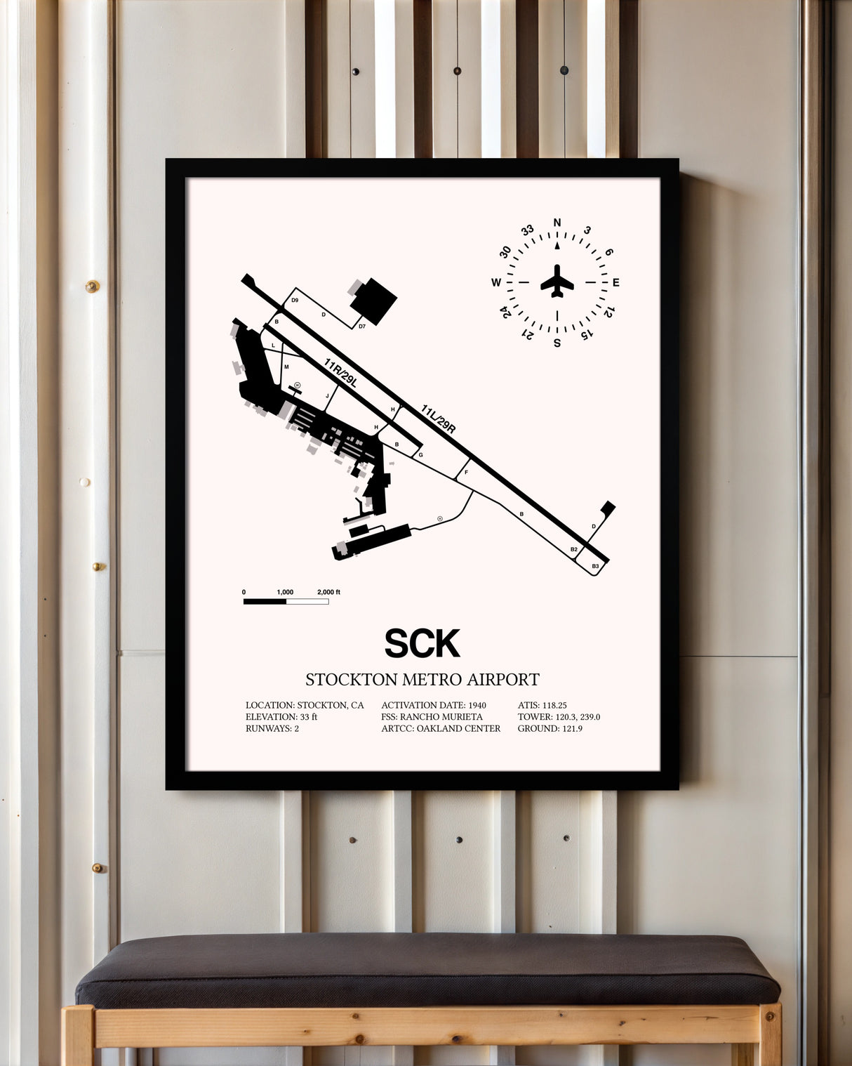 Stockton Metro Airport framed poster displayed in an airplane hangar