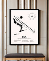 Stockton Metro Airport framed poster displayed in an airplane hangar