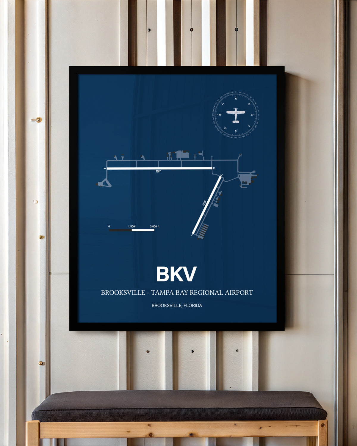 Brooksville-Tampa Bay Regional Airport framed poster displayed in an airplane hangar