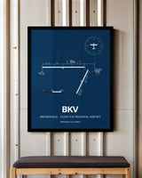 Brooksville-Tampa Bay Regional Airport framed poster displayed in an airplane hangar
