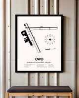 Norwood Memorial Airport framed poster displayed in an airplane hangar